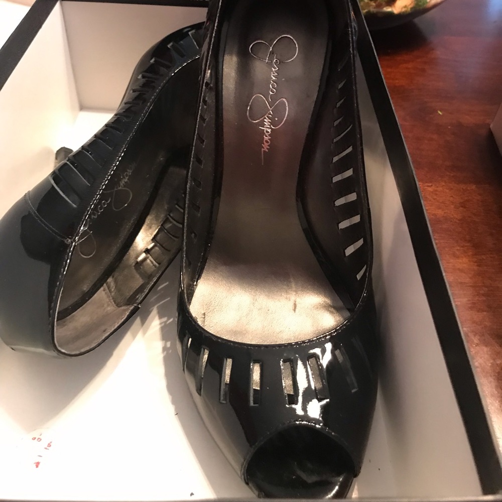 Gloss black women’s high heel opened toe shoe.